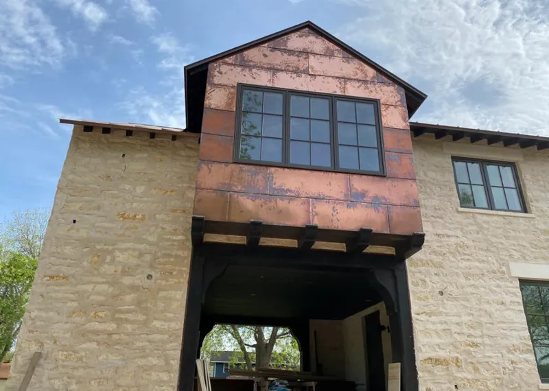 Copper metal panel facade on a stone building for Skylight Installation in La Verne